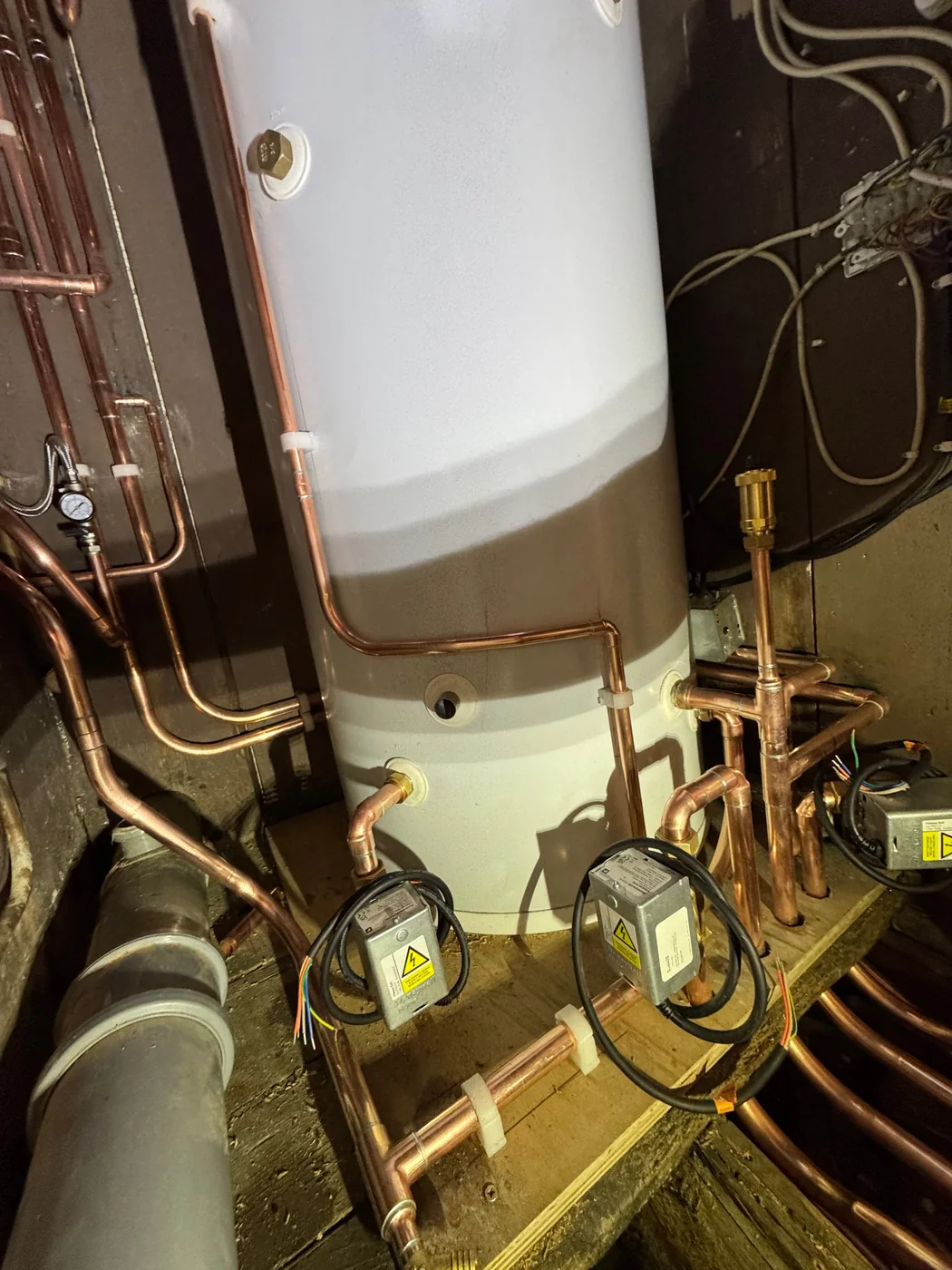 Hot water cylinder with motorised zone valves and copper pipework, installed by Heritage Heating Services
