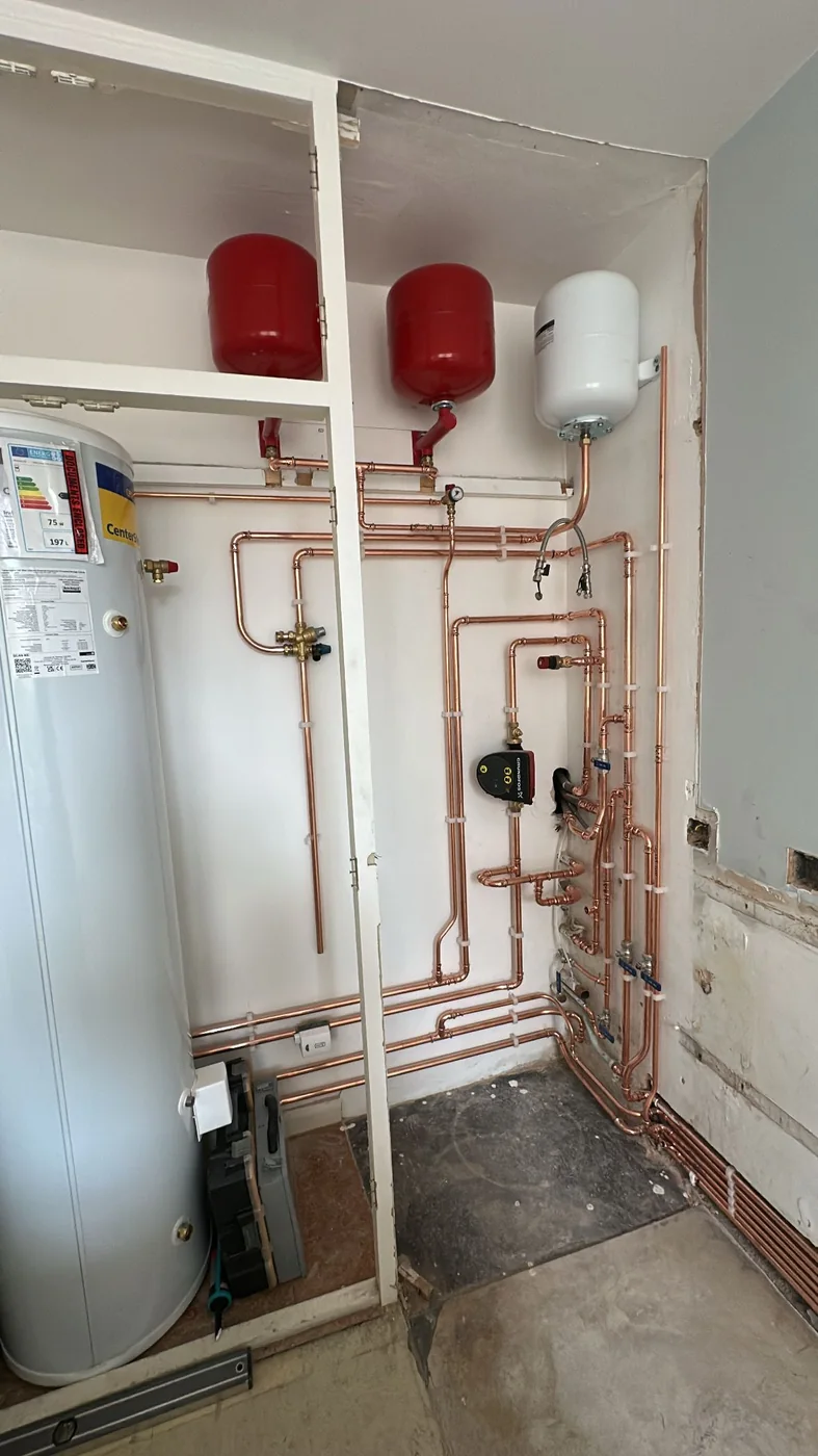 Hot water cylinder with expansion vessels, system pump and copper pipework, installed by Heritage Heating Services