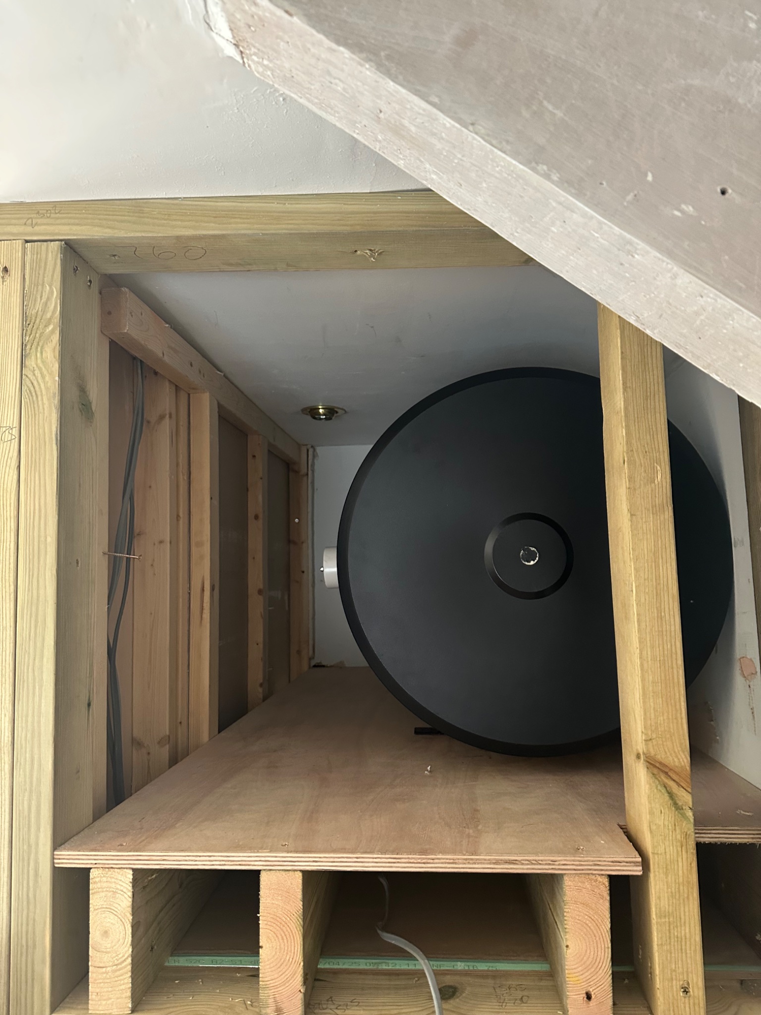 Timber cubby framed above a stairwell to take a horizontal unvented cylinder in Bath