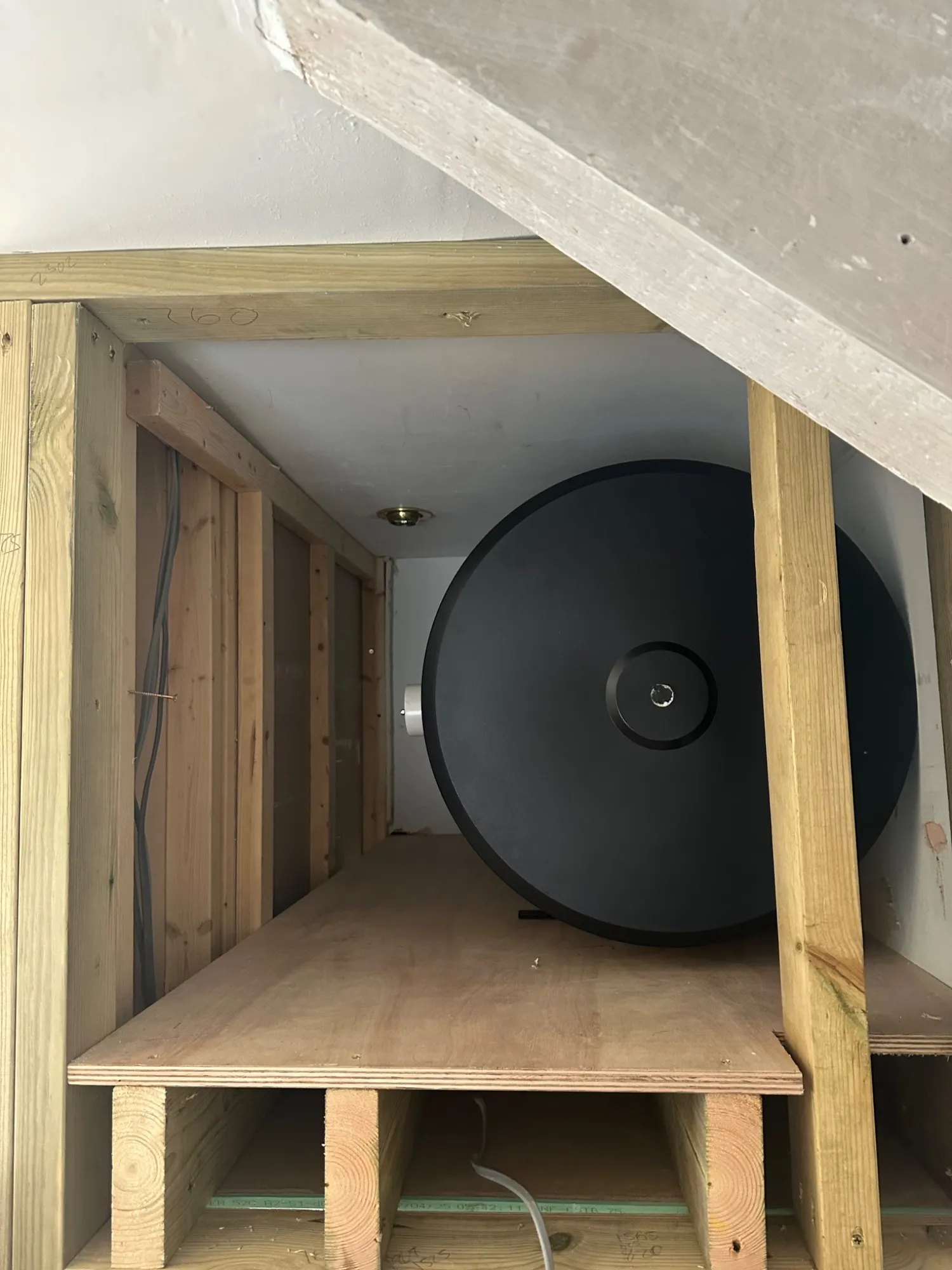 Timber cubby framed above a stairwell to take a horizontal unvented cylinder in Bath