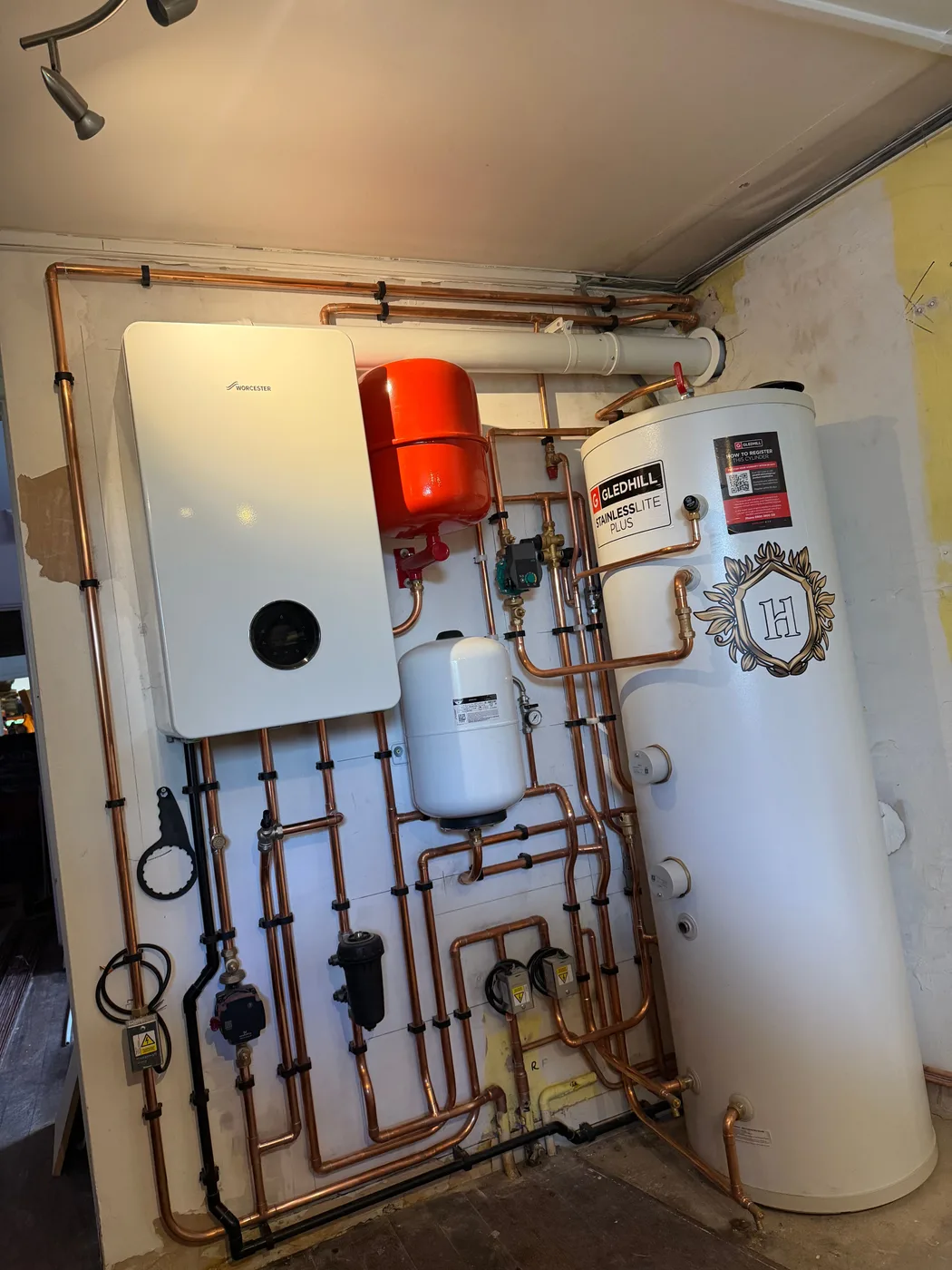 Worcester Bosch boiler and Gledhill unvented cylinder with neat copper pipework, installed by Heritage Heating Services